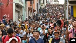 FILE - Migrants begin their journey north in hopes of reaching the US border, in Tapachula, Chiapas state, Mexico, April 23, 2023. 