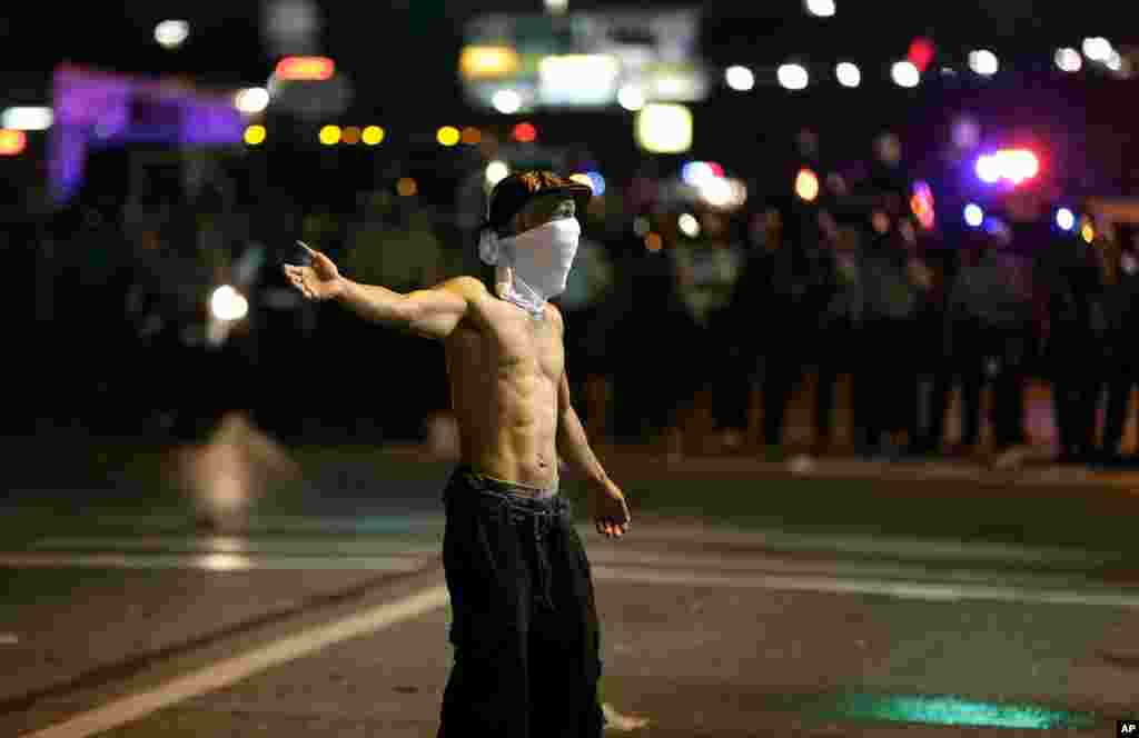 A man participates in a protest for Michael Brown, who was shot and killed by a police officer, Ferguson, Missouri, Aug. 18, 2014.