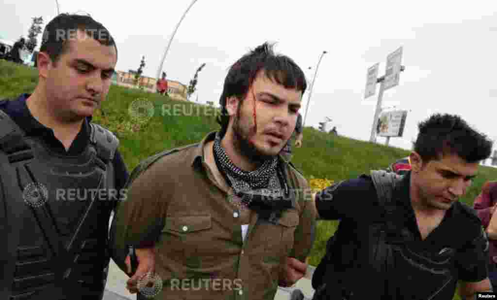 Riot police detain a protester as he and others demonstrate to blame the ruling AK Party (AKP) government on mining disaster in western Turkey, in Ankara May 14, 2014. Rescuers pulled more dead and injured from a coal mine in western Turkey on Wednesday m